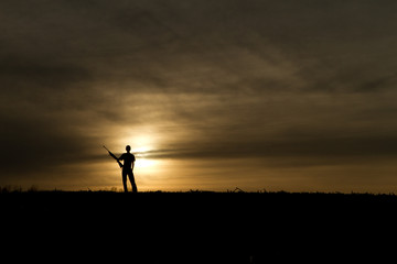 Fototapeta na wymiar small game hunter in the sunset 