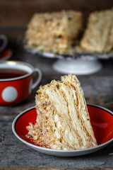 cake - Napoleon (puff cake with white cream) on a wooden table