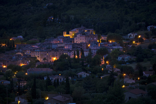 Night view of Seillans, atmospherically lit village on a hillside