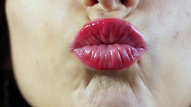young woman sending kiss, close up and slow motion