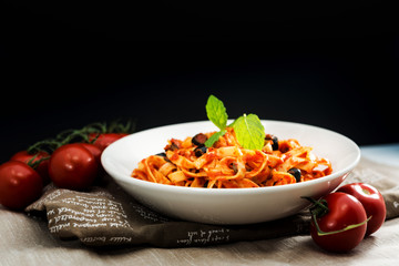 Spaghetti with aubergine and tomato sauce on a the table