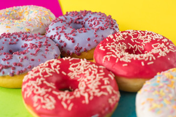 donuts on a beautiful colored background, pastel glamor colors
