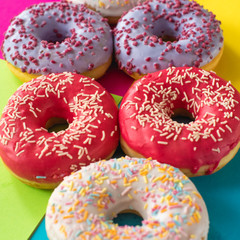 donuts on a beautiful colored background, pastel glamor colors