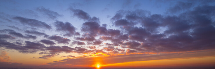 Naklejka na ściany i meble Fiery sunset, colorful clouds in the sky,panorama