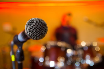 Microphone on bright blurred orange bacckground