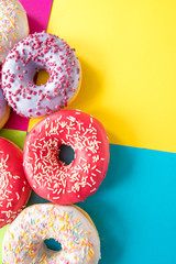 donuts on a beautiful colored background, pastel glamor colors