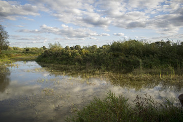 Amazing clouds at sunset over a river in country-side