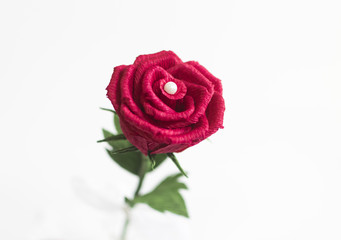 Red paper rose on white background
