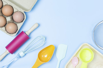 Baking utensils tool pastel style on blue background topview flatlay copyspace.