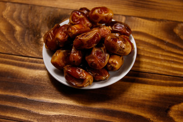 Dried dates fruit on wooden table