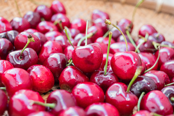 Fresh cherry on wooden basket