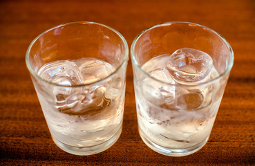 Two glasses of Malibu and ice on the bar counter 