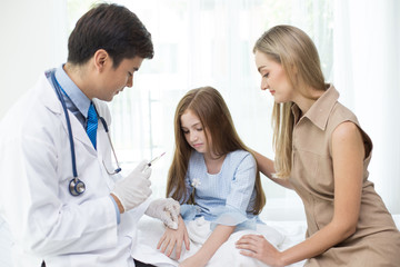 Fototapeta premium Girl scary to injection from doctor at hospital. People with medical and health care concept.