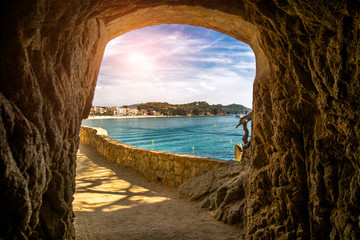 Views of Lloret de Mar over the grotto in the rock  - obrazy, fototapety, plakaty