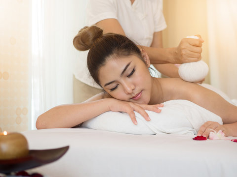 Beautiful young woman receiving massage in spa salon