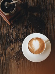 Top view of coffee latte art on wooden table.