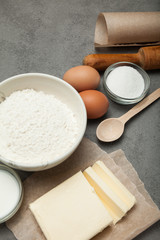 Kitchen gray table with utensils and ingredients for baking.