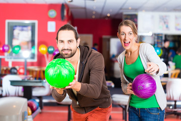 Couple playing Bowling at bowling center