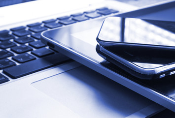Close up stack of smartphone on labtop , technology concept.