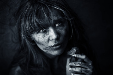 Dirty orphan with a piece of bread