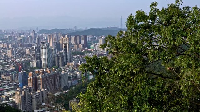 4k Top view of the downtown Taipei city from the mountain. Beautiful aerial view of cityscape with apartment buildings in Xindian. Buildings with oficines of capital daytime-Dan