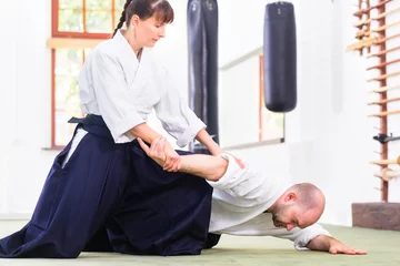 Foto op Plexiglas Man and woman fighting at Aikido training in martial arts school  © Kzenon
