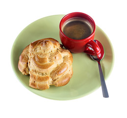 delicious eclair and cup of coffee on a green plate isolated on a white background