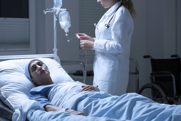 Nurse helping dying woman