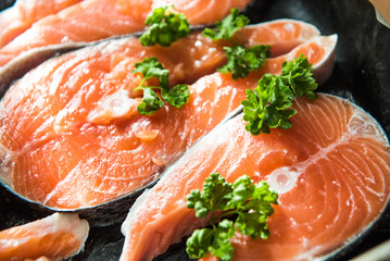 the fresh fish stakes with greens which are laid out on a baking sheet sunlight