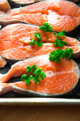 the fresh fish stakes with greens which are laid out on a baking sheet sunlight