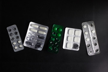 white pills on black background.