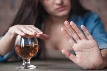 Young woman alcoholic social problems concept sitting looking at hand