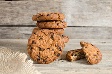 Chocolate chip cookies. Burlap and old wooden table.