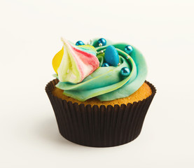 Tasty muffin with buttercream isolated on white