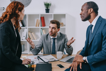 Financial adviser talking with two business partners