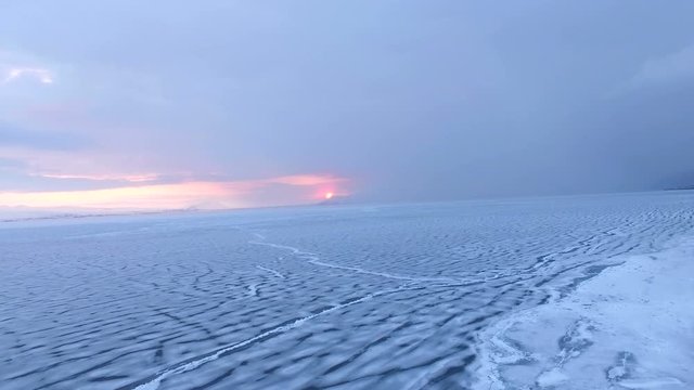 Flying over iced sea or lake by helicopter .