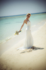 Fototapeta na wymiar Beautiful bride on a tropical beach wedding day
