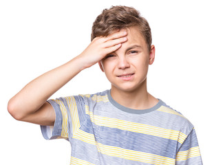 Naklejka premium Stress and headache - teen boy having migraine pain. Handsome child suffering from a headache. Unhappy caucasian teenager touching his head, isolated on white background.