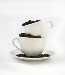 White coffee cups with coffee beans on white background