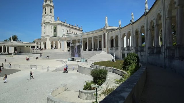 Perspective view of staircase of Basilica of Nossa Senhora of Sanctuary of Fatima in Portugal. Blue sky in a beautiful day. Fatima is one of the most famous travel destinations for Catholic pilgrimage