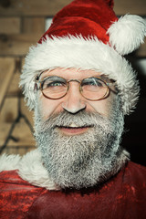 New Year, Christmas and winter time - smiling bearded santa claus in glasses with frozen beard. Waiting Christmas and New Year.