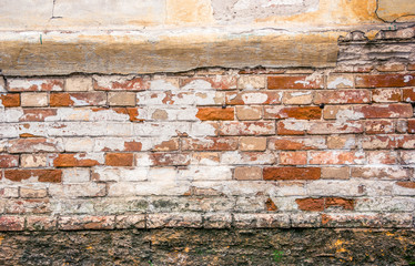 Old brick wall, foundation and plaster..The wall of the old house.