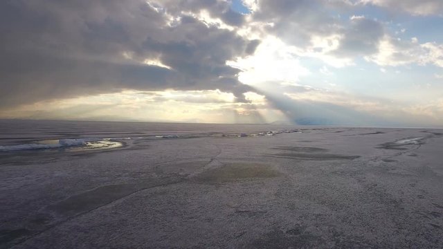 Flying over iced sea or lake by helicopter .