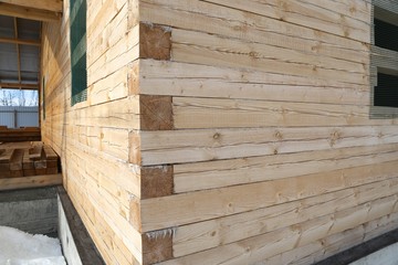 construction of the wooden house from a bar square dry after winter