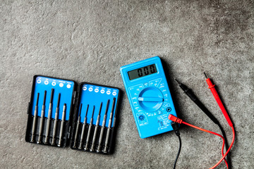 Digital multimeter on grey background