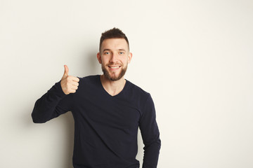 Cheerful man showing like, thumb-up gesture