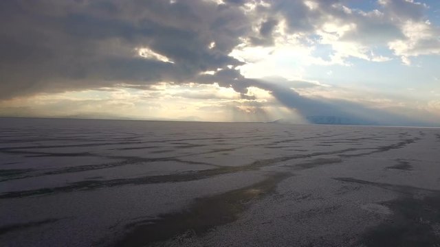 Flying over iced sea or lake by helicopter .