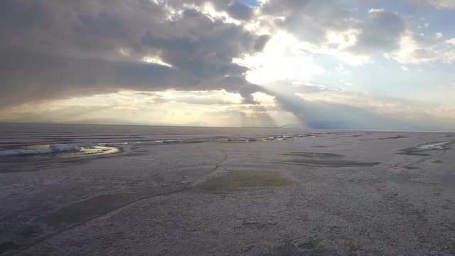 Flying over iced sea or lake by helicopter .