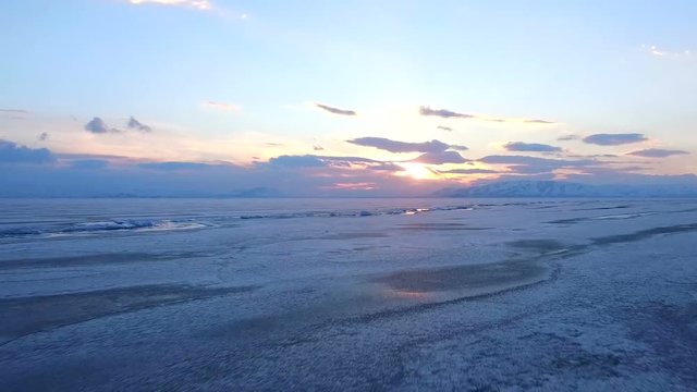 Flying over iced sea or lake by helicopter .