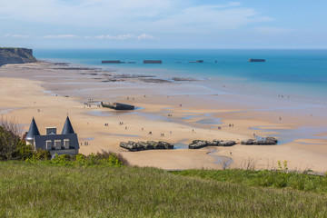 Arromanches-les-Bains beach with the remains of the Mulberry harbour in Normandy, France